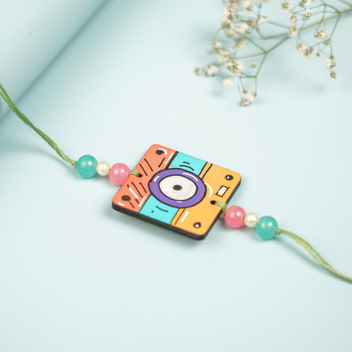 Customized Hand Painted Camera Design Mdf Wood Rakhi - Angled Side View Showing Depth