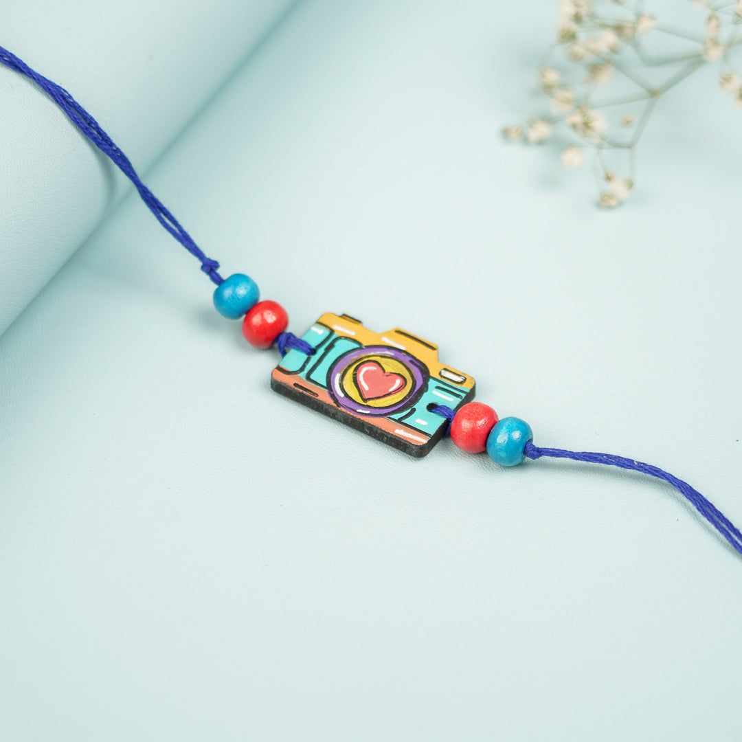 Customized Hand Painted Camera Design Mdf Wood Rakhi - Angled Side View Showing Depth (4)