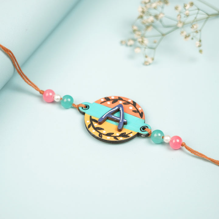 Personalized Hand Painted Layered Monogram Design Mdf Wood Rakhi - Close-up Angle (4)