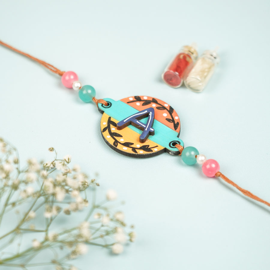 Personalized Hand Painted Layered Monogram Design Mdf Wood Rakhi - Front View