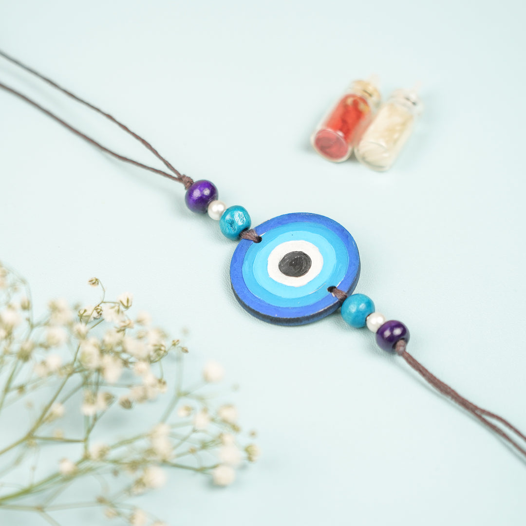 Customized Hand Painted Evil Eye Design Mdf Wood Rakhi - Front View Displaying Circular Pendant
