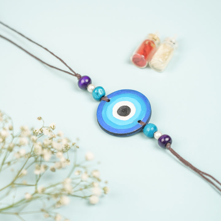 Customized Hand Painted Evil Eye Design Mdf Wood Rakhi - Front View Displaying Circular Pendant