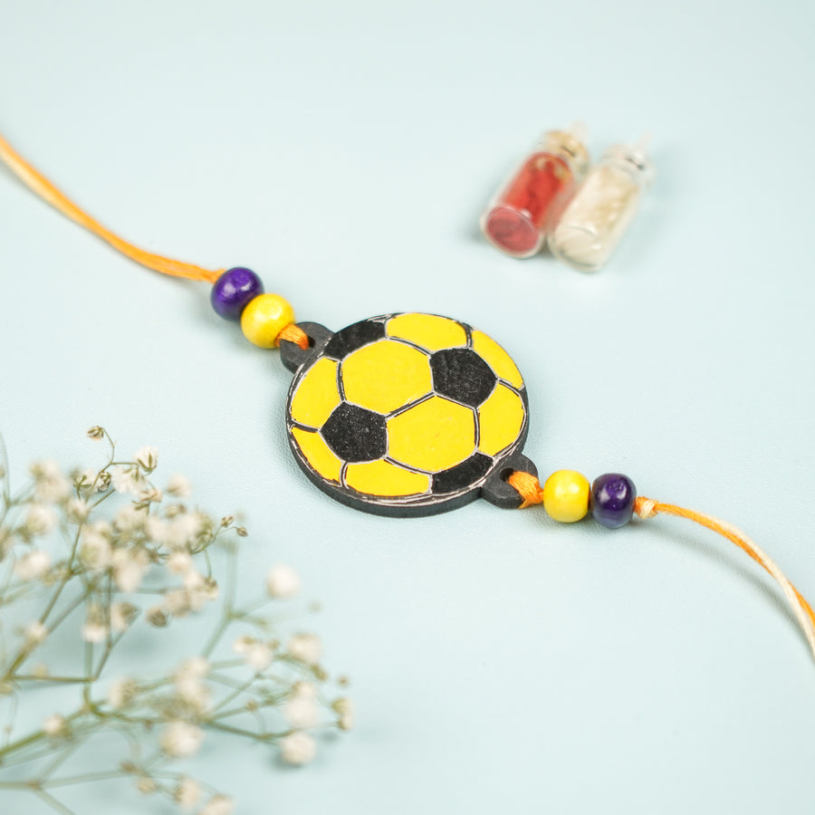 Hand Painted Football Design Mdf Wood Kids Rakhi - Front View with Decorative Bottles