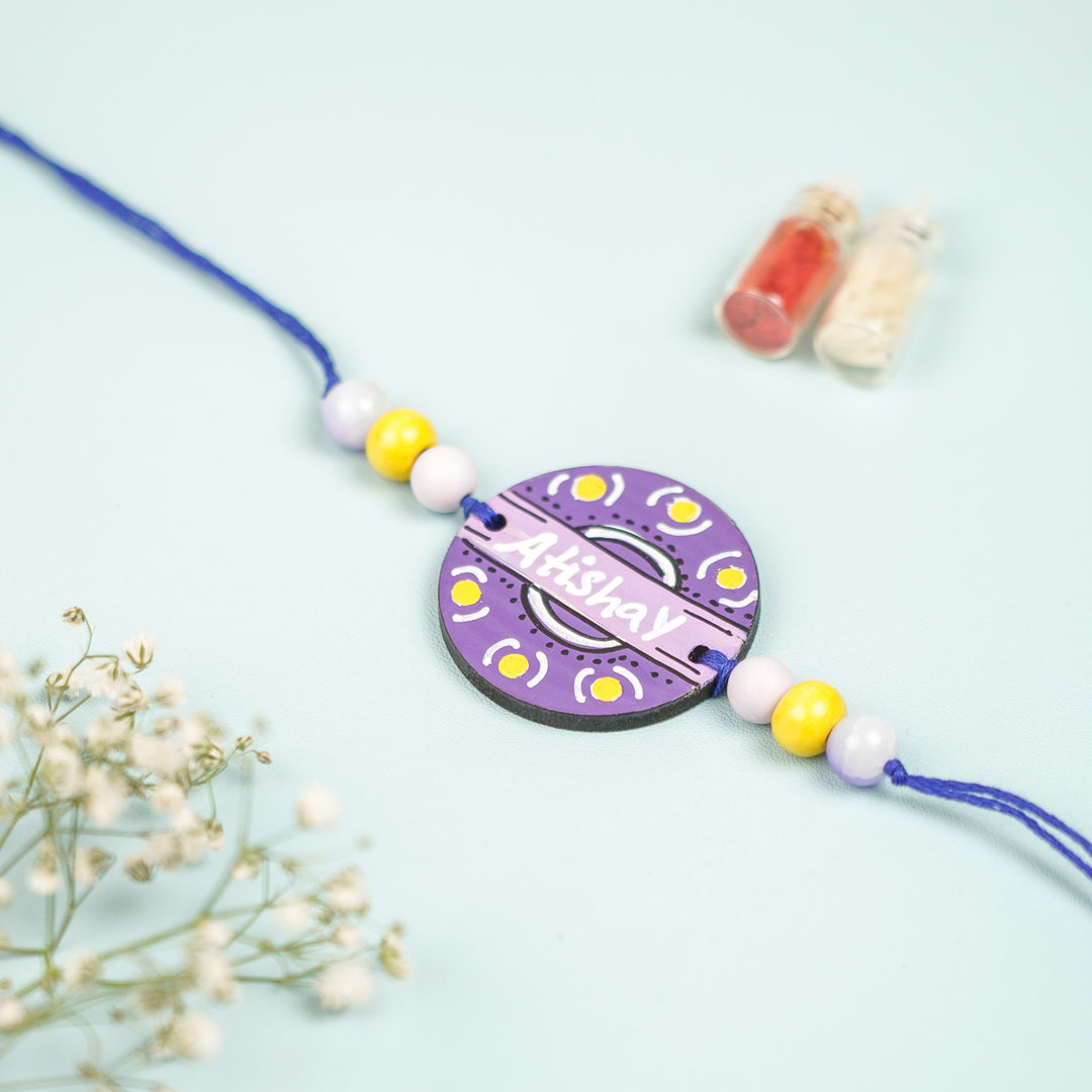 Personalized Hand Painted Round Design Mdf Wood Rakhi - Top View Showing Pendant and Beads