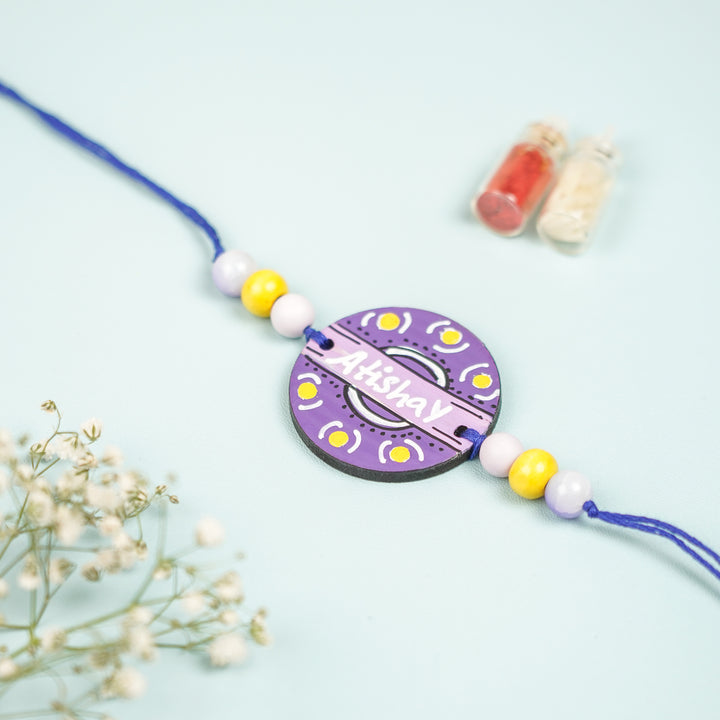 Personalized Hand Painted Round Design Mdf Wood Rakhi - Top View Showing Pendant and Beads