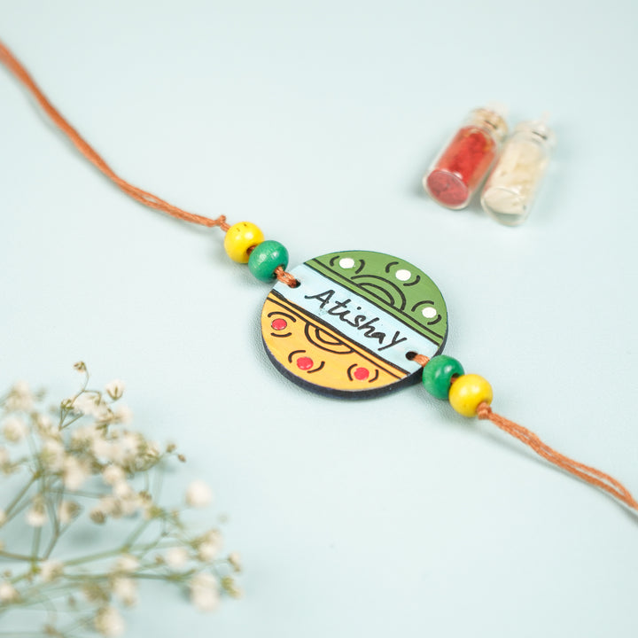 Personalized Hand Painted Round Design Mdf Wood Rakhi - Close-up of Colorful Pendant Design