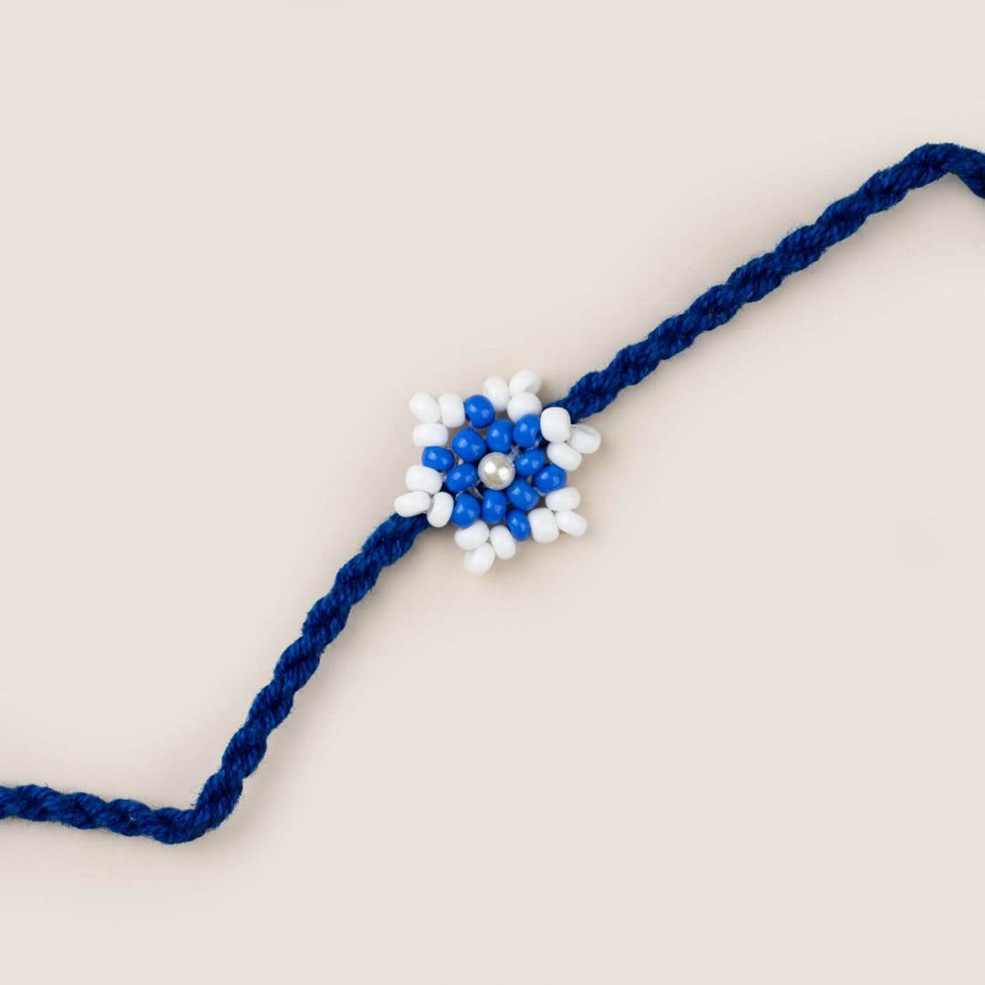 Handcrafted Glass Beads Tara Rakhi 6 - Close-up of blue-white rakhi