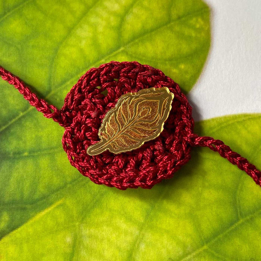 Handmade Crochet Peacock Feather Theme Religious Cotton Rakhi With Roli Chawal - Close-up of Leaf Pin on Crochet