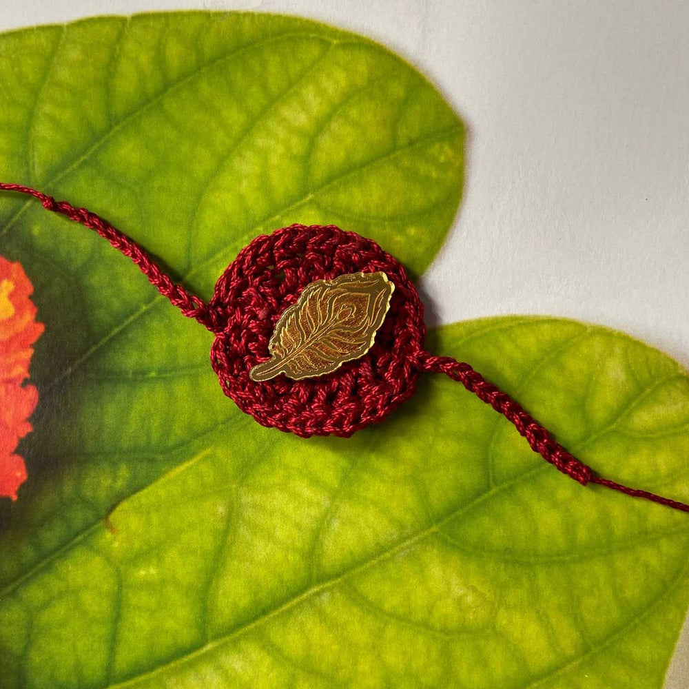Handmade Crochet Peacock Feather Theme Religious Cotton Rakhi With Roli Chawal - Top View of Leaf Pin Bracelet