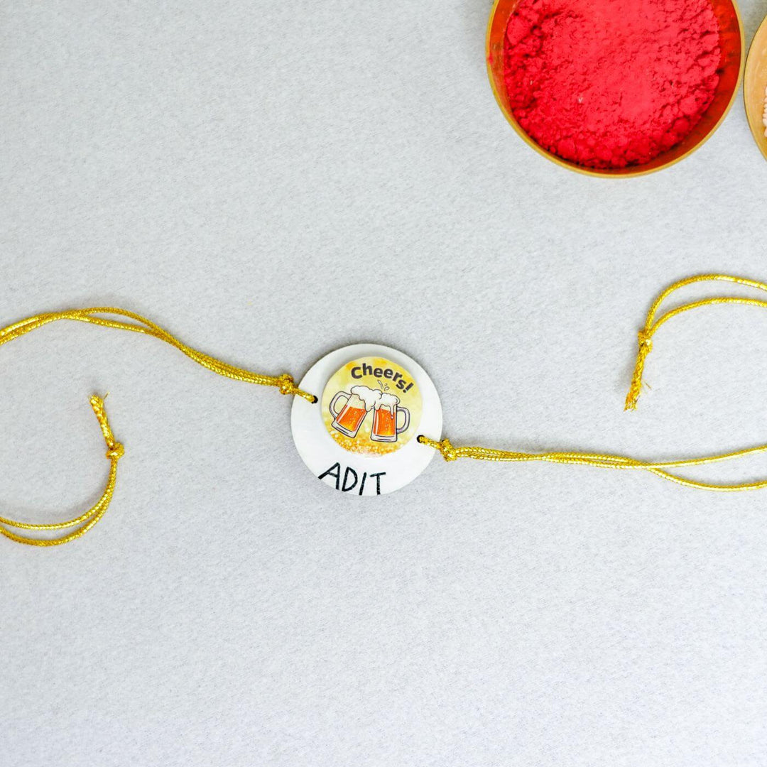 Handmade Personalized Clay Rakhi Keychain With Roli Chawal 1 - Laid Flat with Color Powder