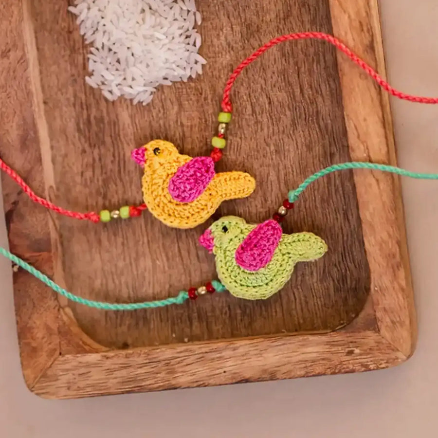 Handmade Crochet Yellow And Green Chidiya Rakhi With Roli Chawal Set Of 2 - Close-up of Bird Charms