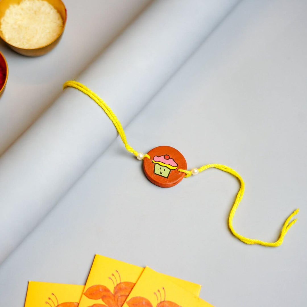 Hand-painted Cupcake Terracotta Rakhi With Roli Chawale