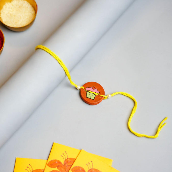 Hand-painted Cupcake Terracotta Rakhi With Roli Chawale