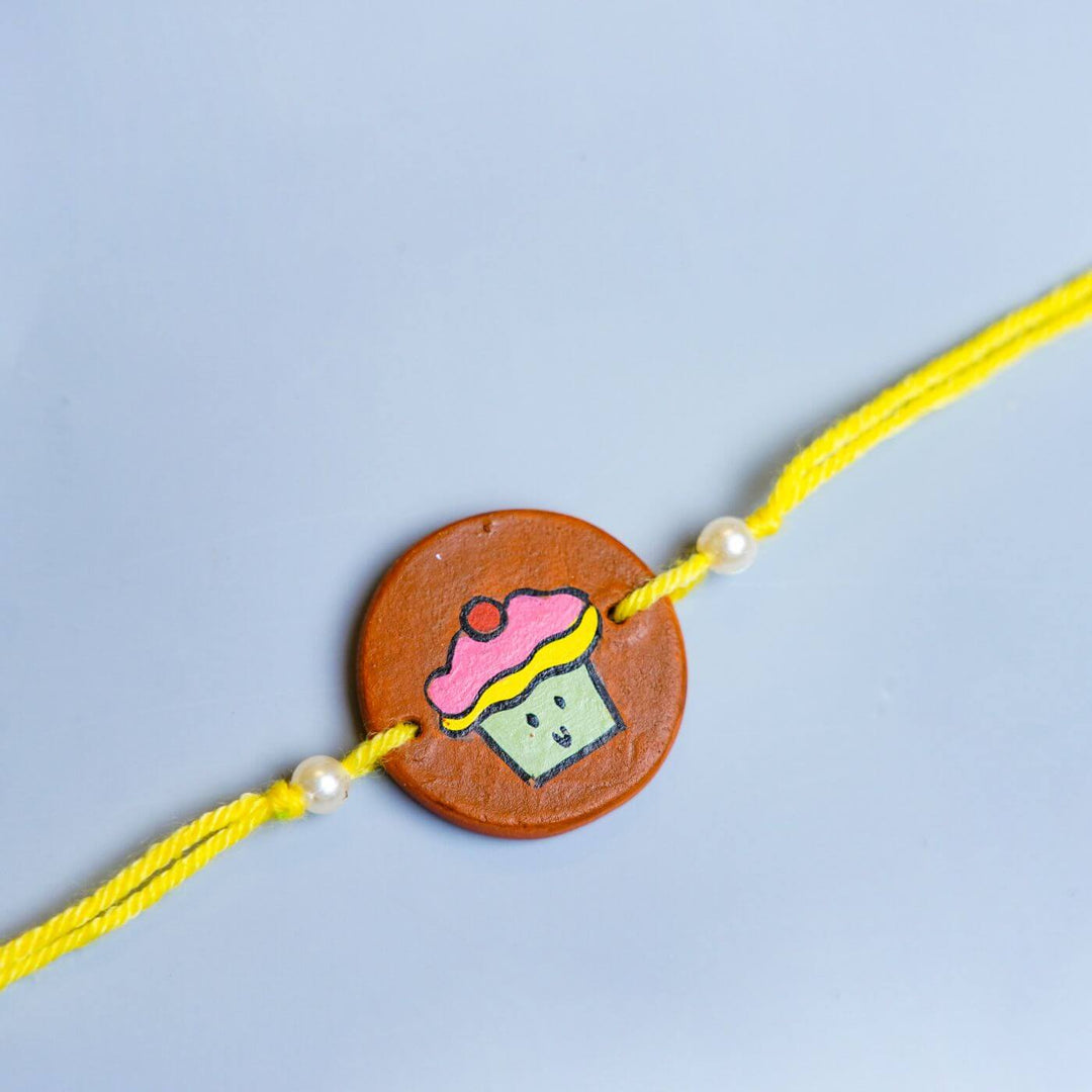 Hand-painted Cupcake Terracotta Rakhi With Roli Chawale