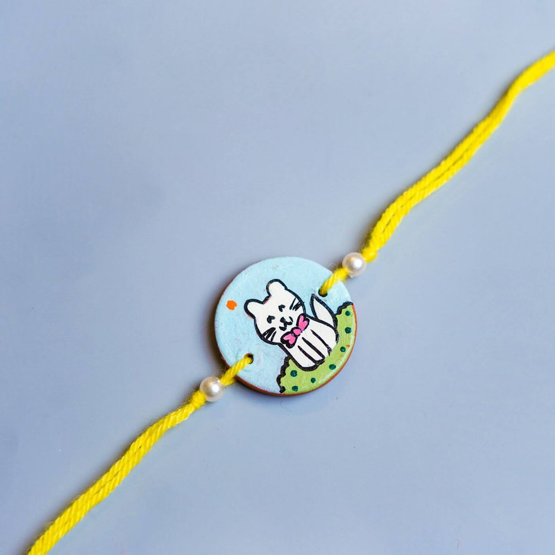 Personalized Animal Theme Terracotta Rakhi With Roli Chawal For Kids 2 - Close-up of Cat Charm