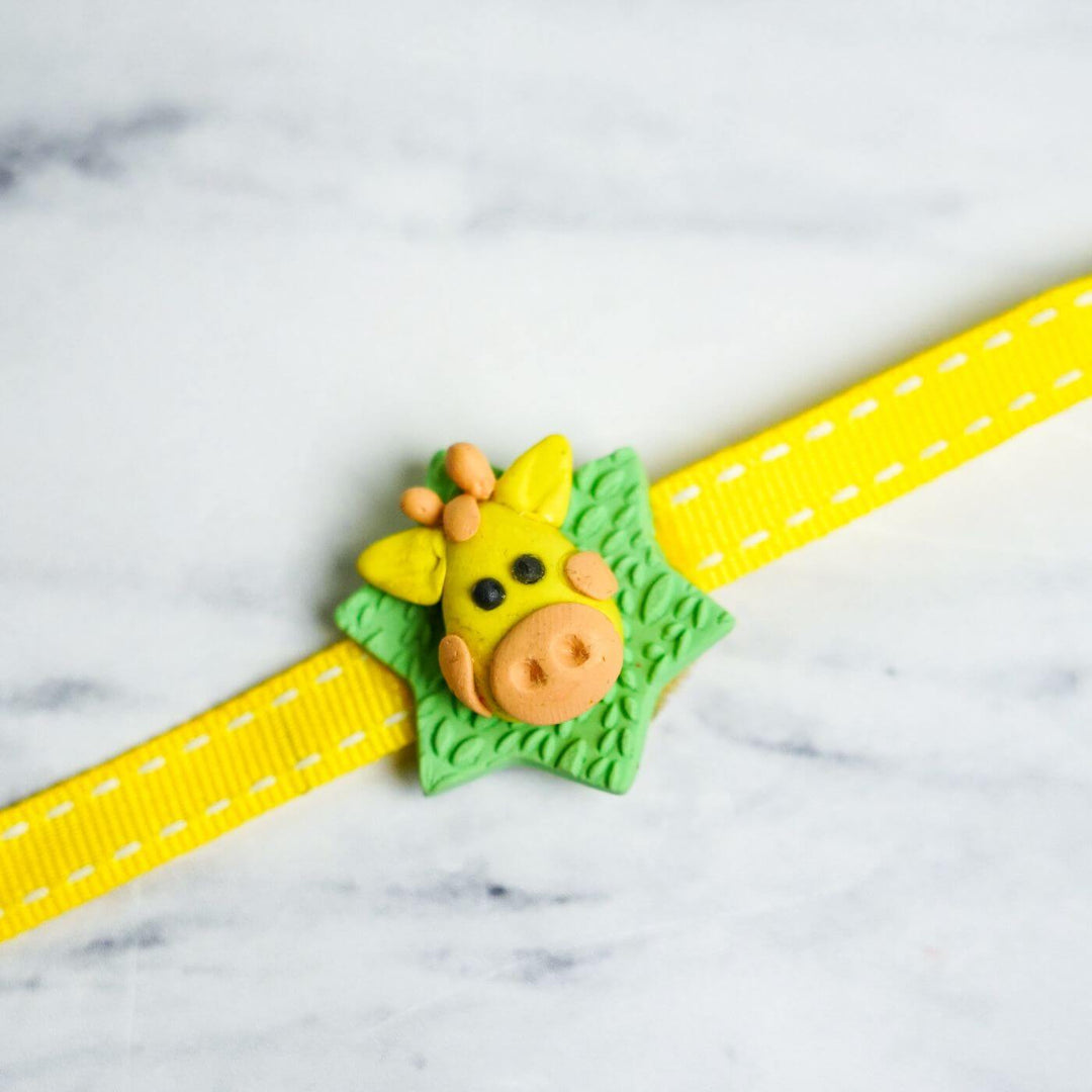 Handmade Porcelain Clay Themed Rakhi 8 - Close-up of Giraffe Charm