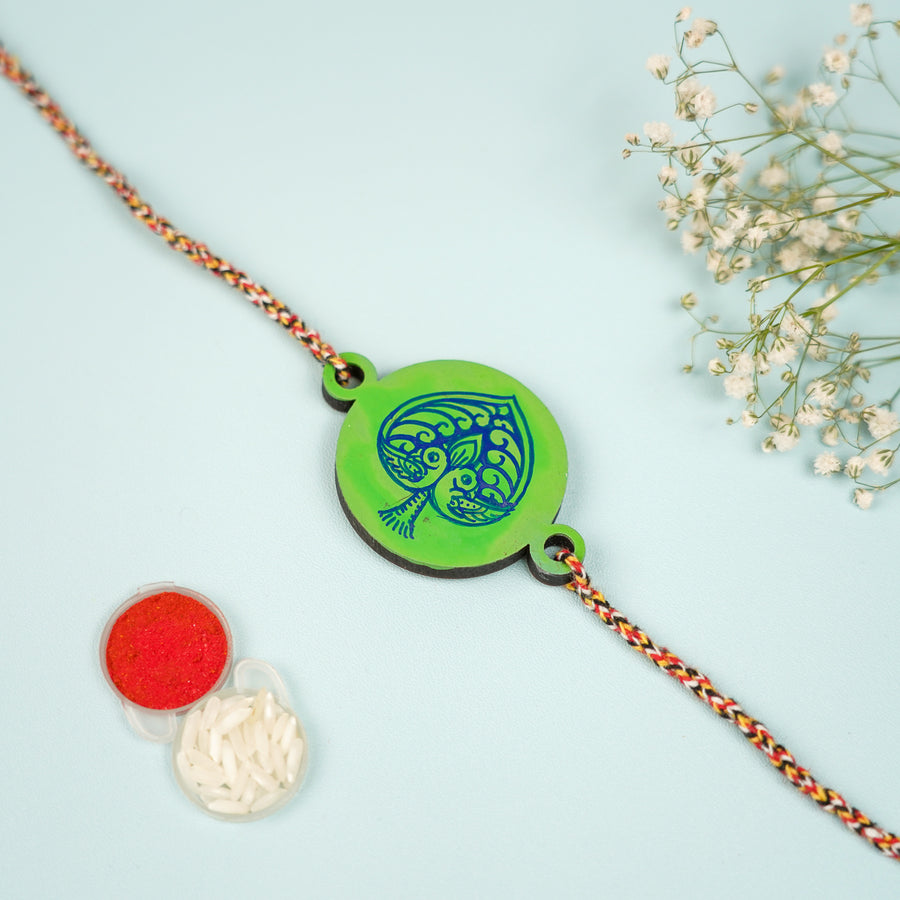 Hand Painted Pattachitra Peacock Heart Design Wooden Rakhi With Roli Chawal For Brother - Front View with Accessories