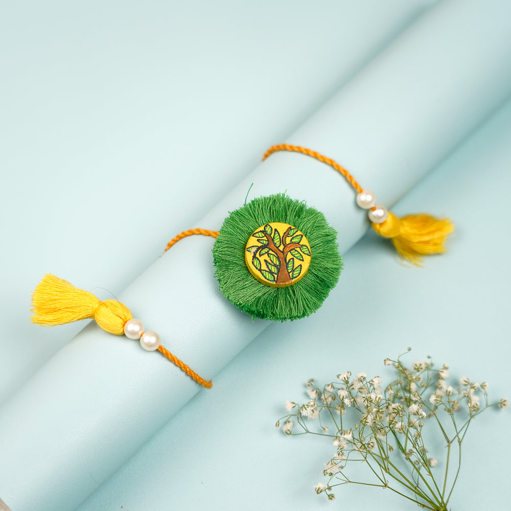 Hand Painted Madhubani Leaves Design Wooden Rakhi With Roli Chawal For Brother - Rolled Display with Floral Accent