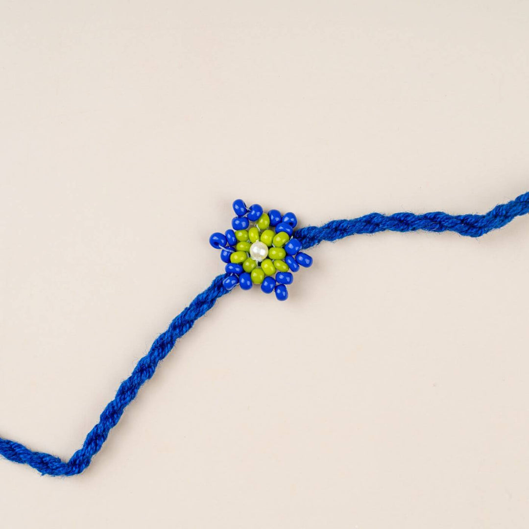 Handcrafted Glass Beads Tara Rakhi 6 - Close-up of blue-green rakhi