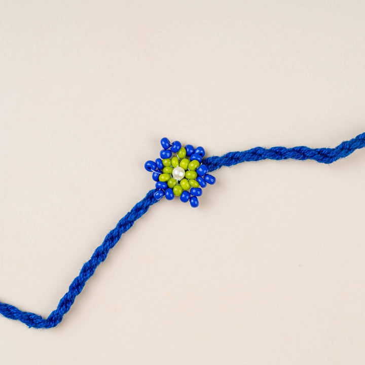 Handcrafted Glass Beads Tara Rakhi 6 - Close-up of blue-green rakhi