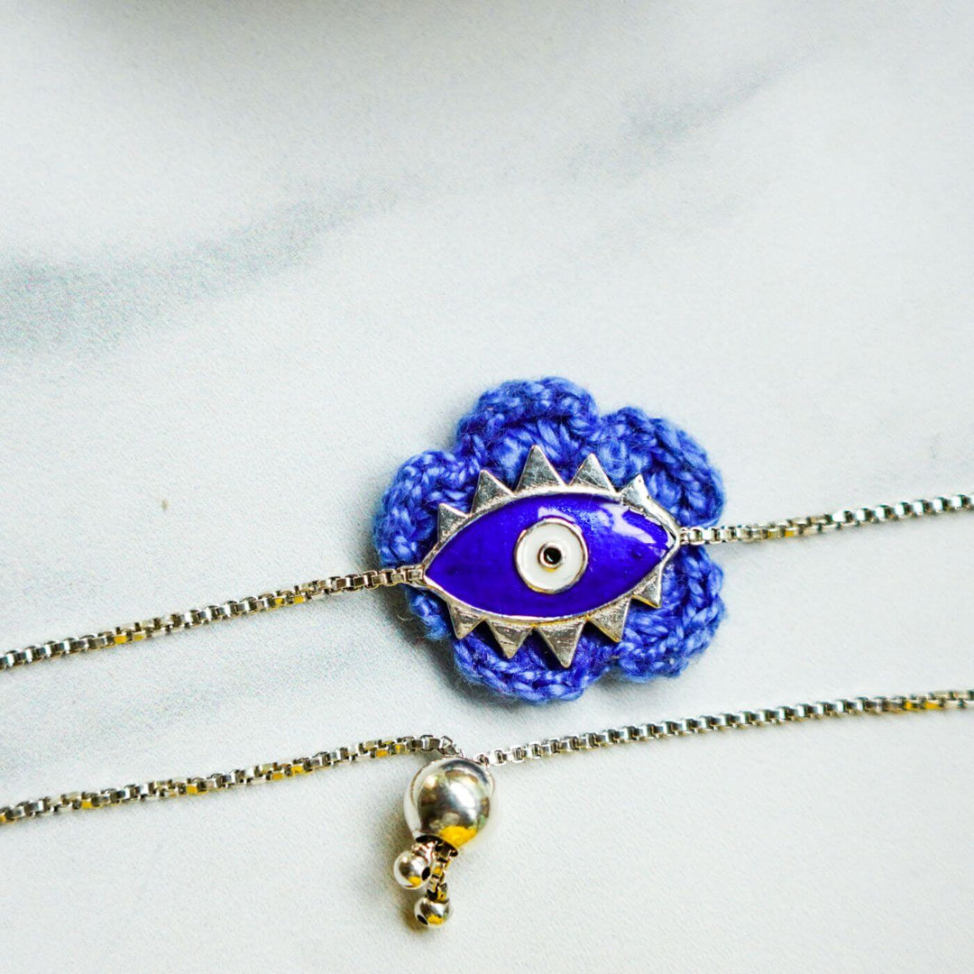 Handcrafted Evil Eye Silver Strap Rakhi For Kids With Rice Roli - Close-up of Alternate Pendant Color
