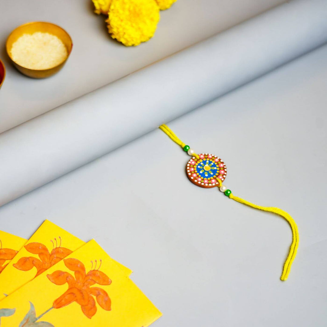 Handpainted Terracotta Rakhi & Mug Set with Roli Chawal