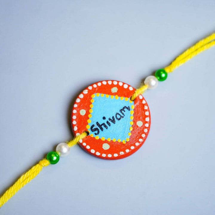Personalized Terracotta Blue & Orange Rakhi With Roli Chawal