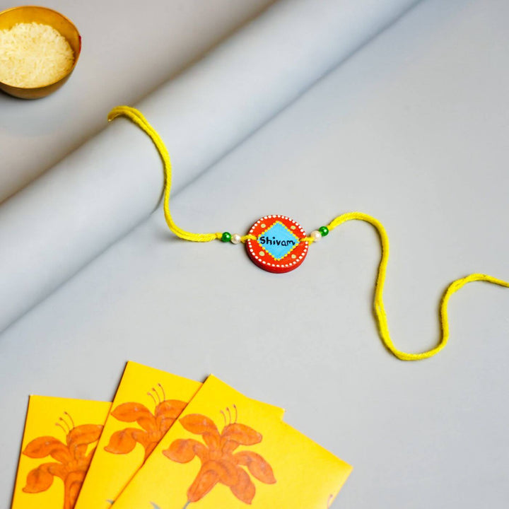 Personalized Terracotta Blue & Orange Rakhi With Roli Chawal