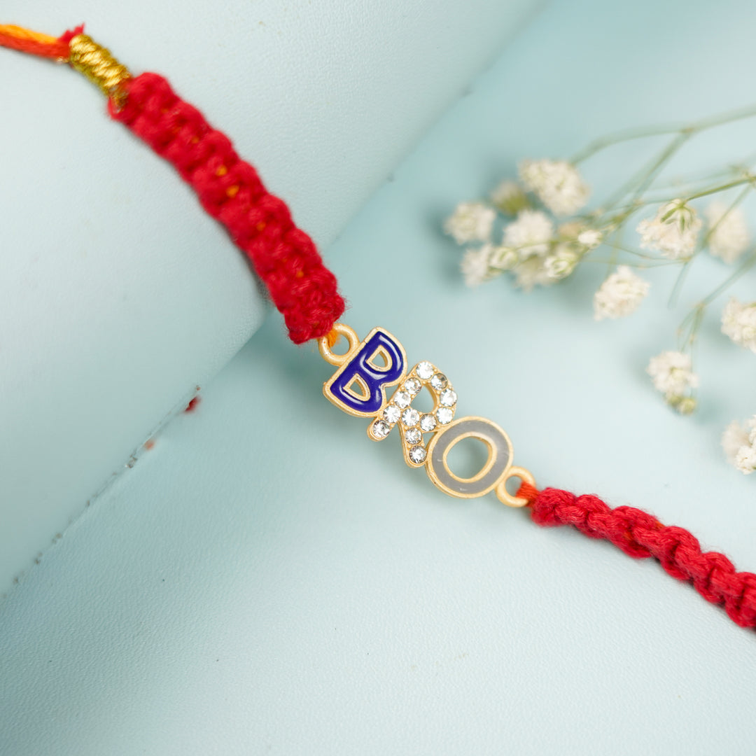 Handmade Macrame Bro Theme Evil Eye Metal Rakhi With Roli Chawal - Close-up of letter charm