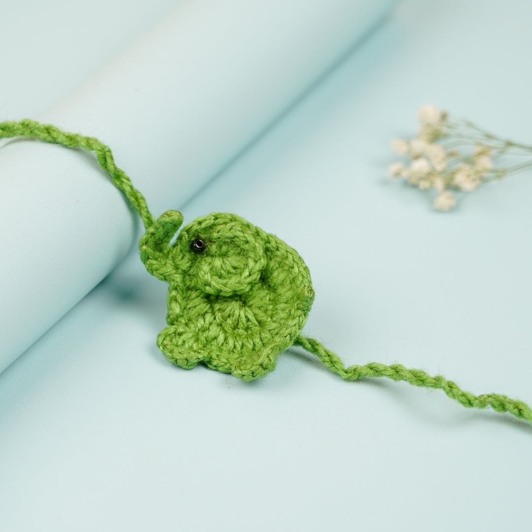 Handmade Crochet Elephant Theme Kids Rakhi With Roli Chawal - Close-up with Rolled Background (4)