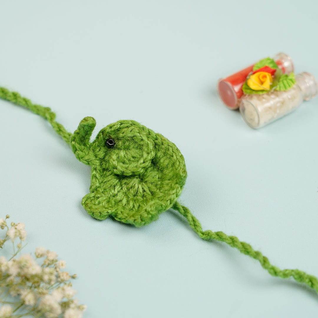 Handmade Crochet Elephant Theme Kids Rakhi With Roli Chawal - Side View with Decorative Bottles (5)