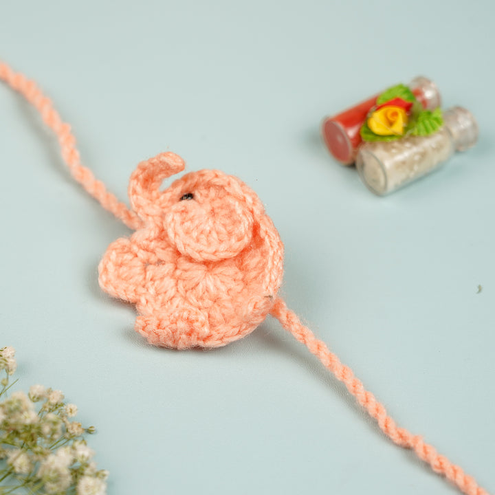 Handmade Crochet Elephant Theme Kids Rakhi With Roli Chawal - Side View with Decorative Bottles (8)