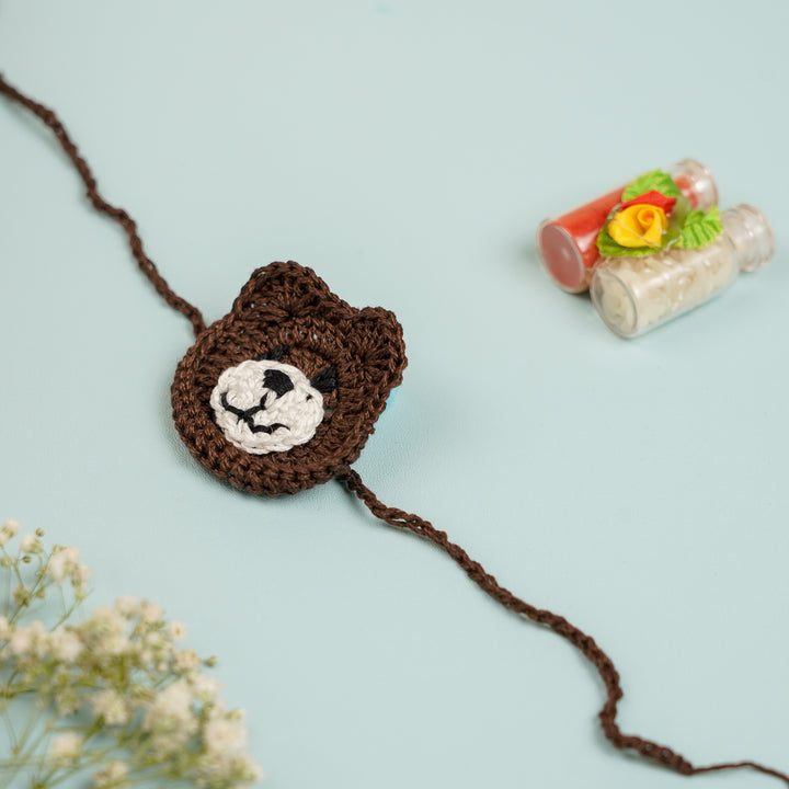 Handmade Crochet Bear Kids Rakhi With Roli Chawal - Front View with Decorative Background (6)