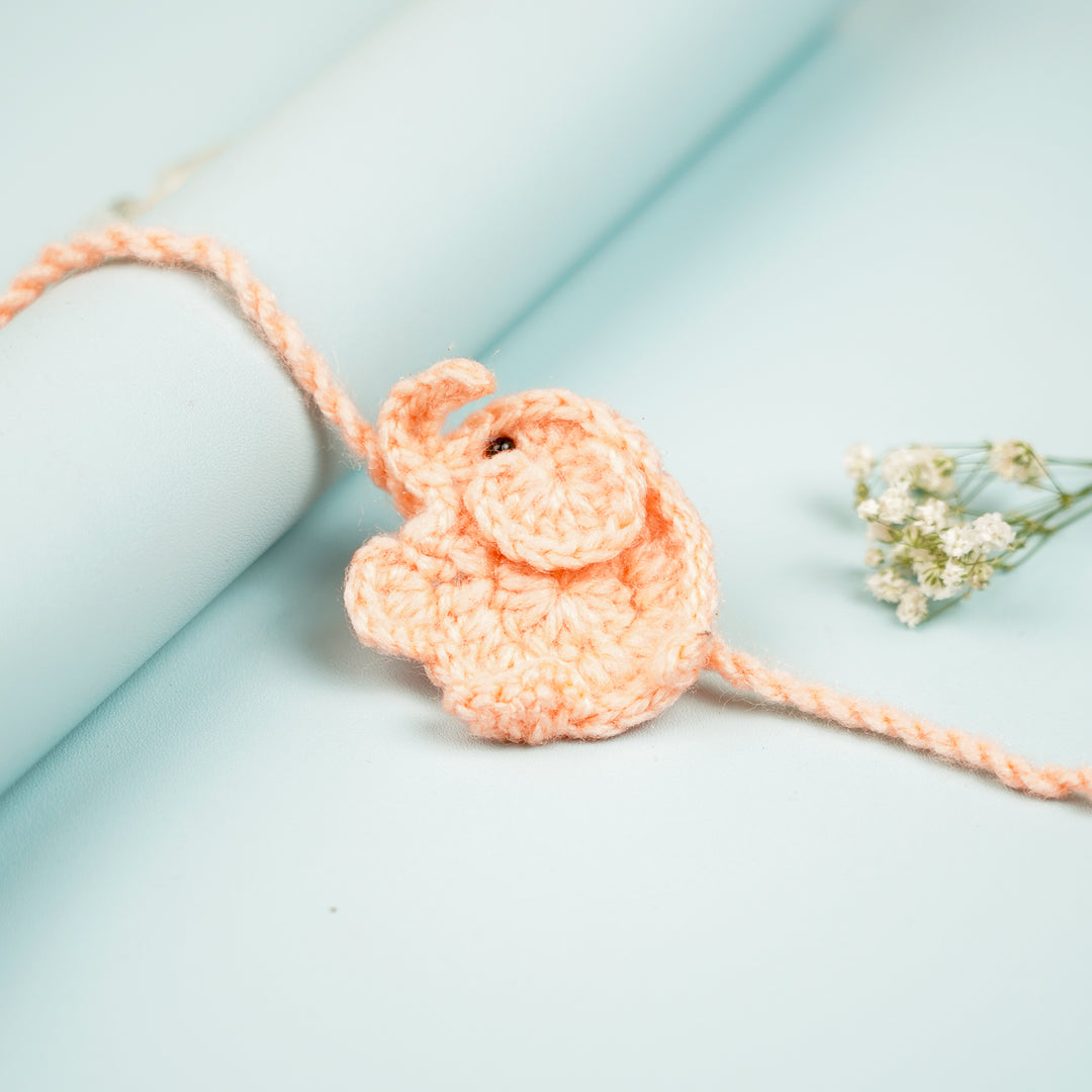 Handmade Crochet Elephant Theme Kids Rakhi With Roli Chawal - Close-up with Rolled Background (7)