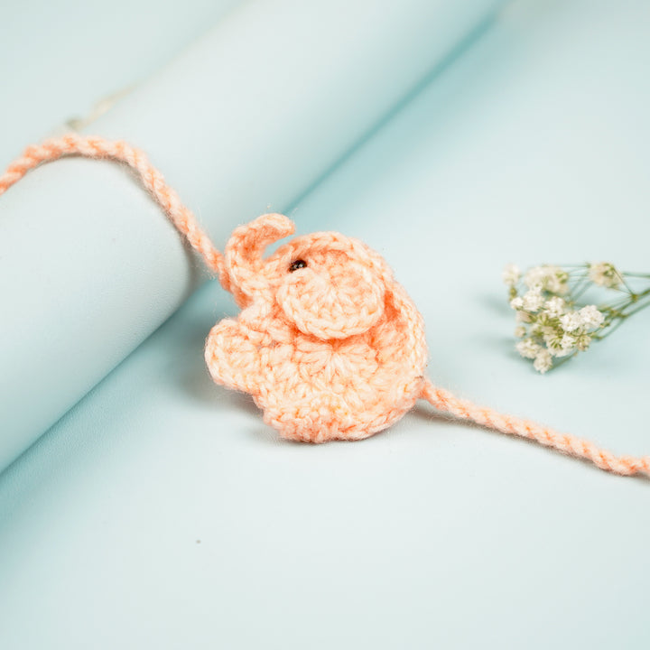 Handmade Crochet Elephant Theme Kids Rakhi With Roli Chawal - Close-up with Rolled Background (7)