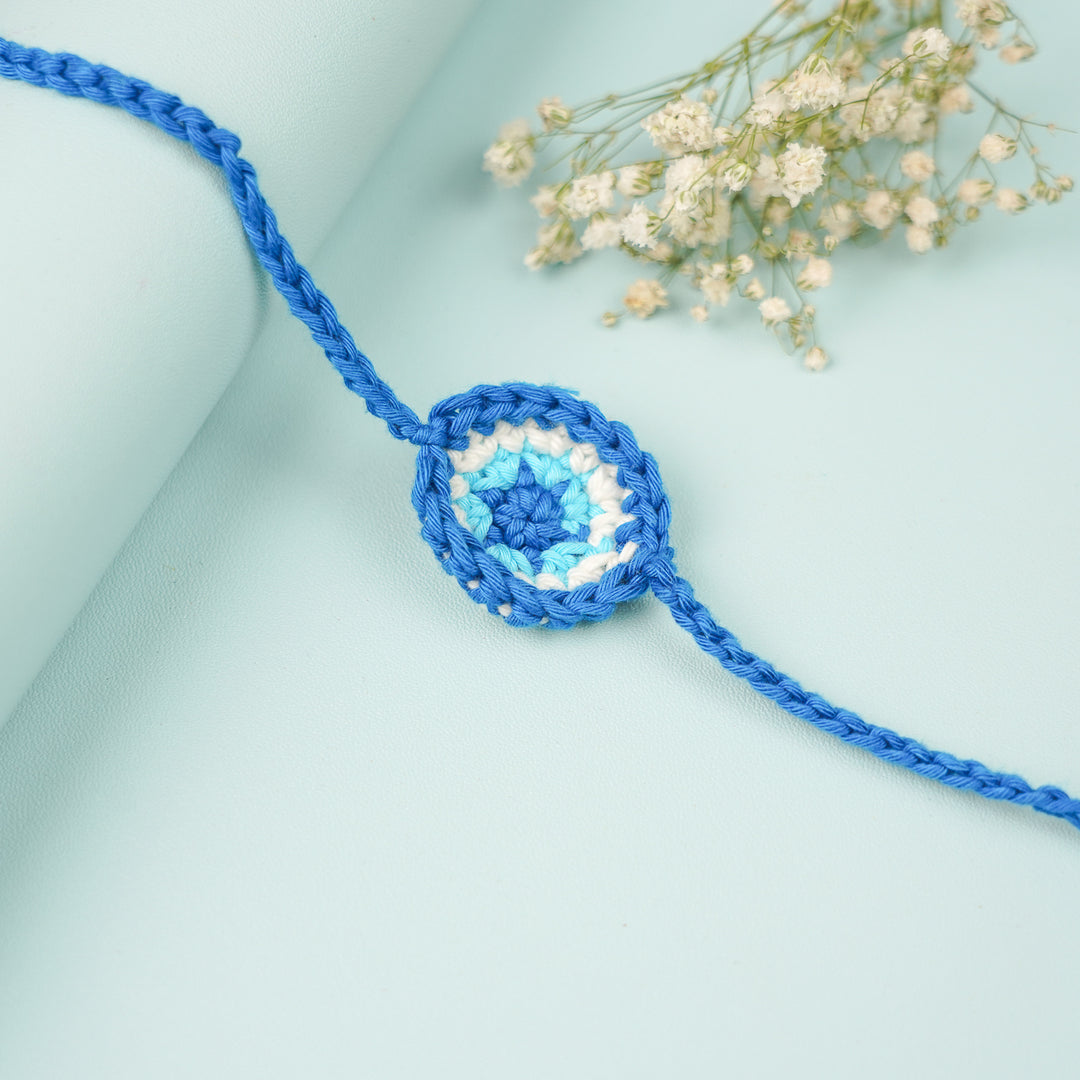 Handmade Crochet Evil Eye Rakhi With Roli Chawal - Close-up of bracelet center