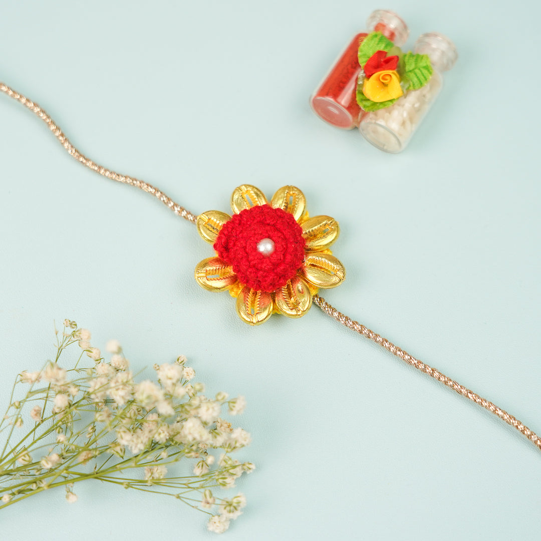 Handmade Crochet Cowry Beaded Floral Rakhi With Roli Chawal - Front View with Flowers and Bottles (5)