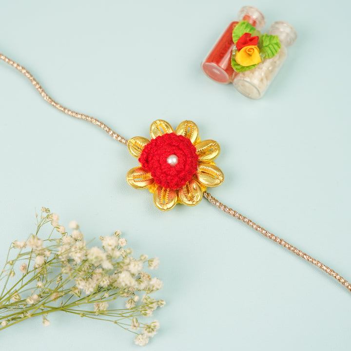 Handmade Crochet Cowry Beaded Floral Rakhi With Roli Chawal - Front View with Flowers and Bottles (5)