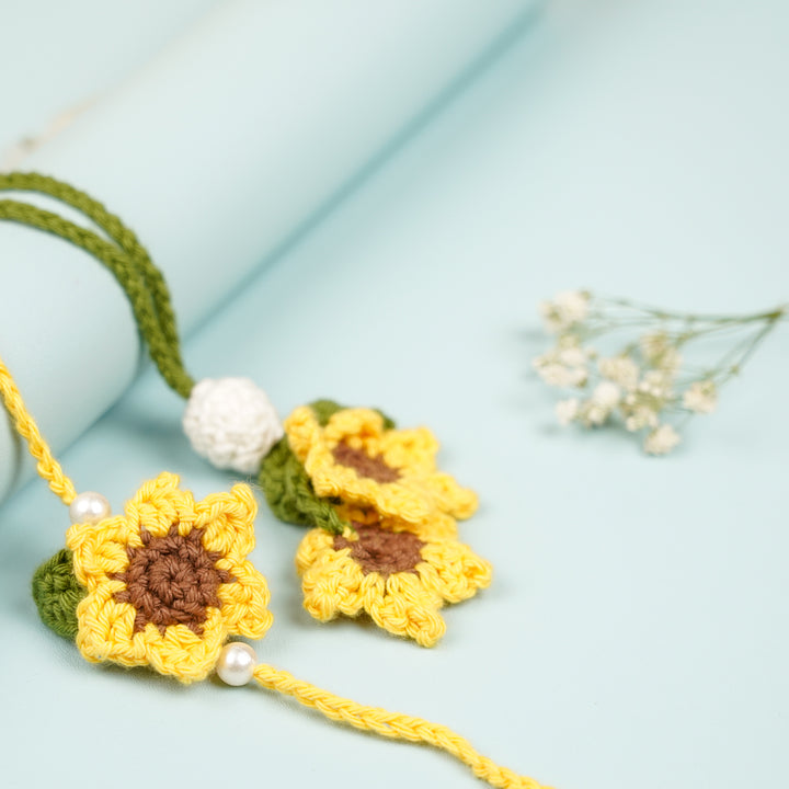 Handmade Crochet Sunflower Bhaiya Bhabhi Rakhi With Roli Chawal Set Of 2 - Angled Close-up with Floral Accent