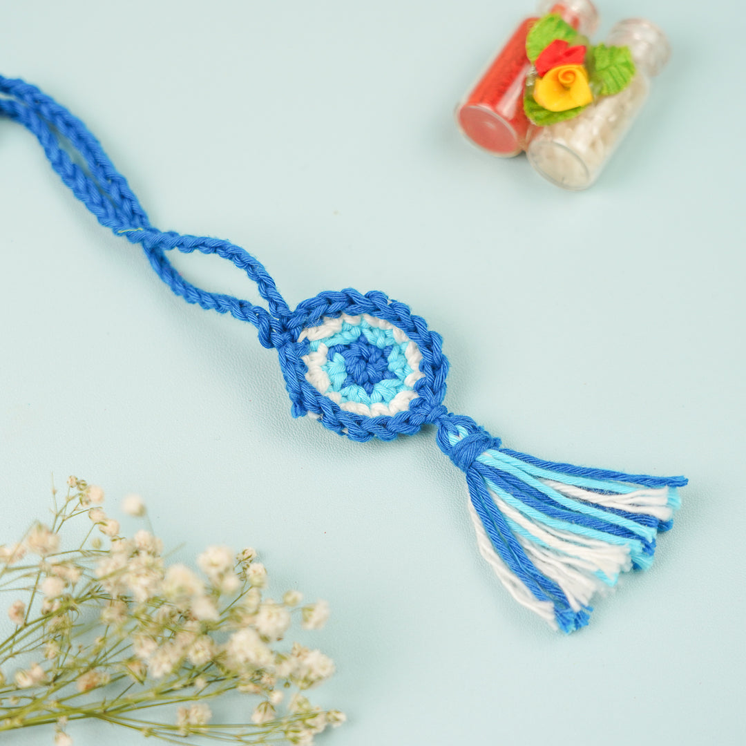Handmade Crochet Evil Eye Lumba Rakhi For Bhabhi With Roli Chawal - Close-up of woven tassel detail