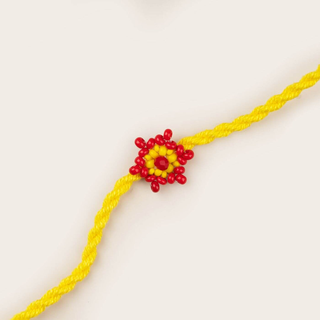 Handcrafted Glass Beads Tara Rakhi 6 - Close-up of yellow rakhi