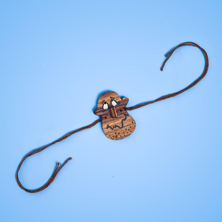 Handpainted Wooden Rakhi Silly Face - Rakhi Laid Flat View