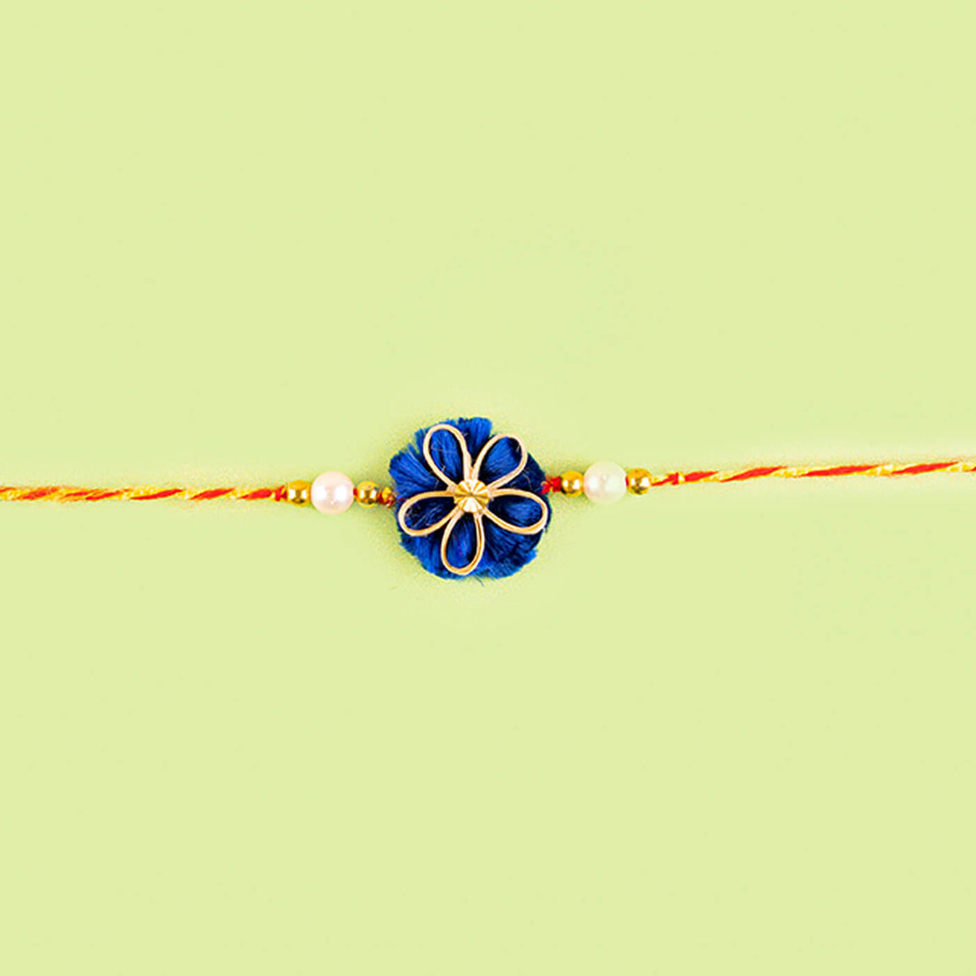 Ecofriendly Quilled Bamboo Rakhi With Golden Bead - Flat Lay with Center Focus