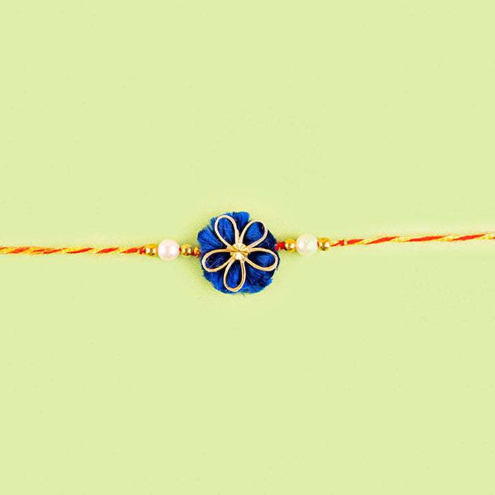 Ecofriendly Quilled Bamboo Rakhi With Golden Bead - Flat Lay with Center Focus