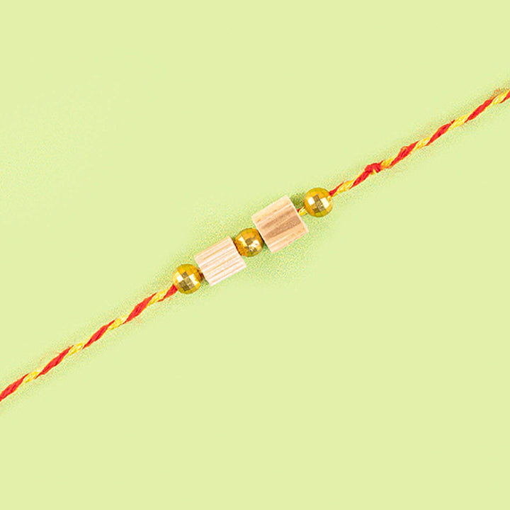 Ecofriendly Bamboo Weaved Quilled Motif Rakhi - Simple bead Rakhi close-up