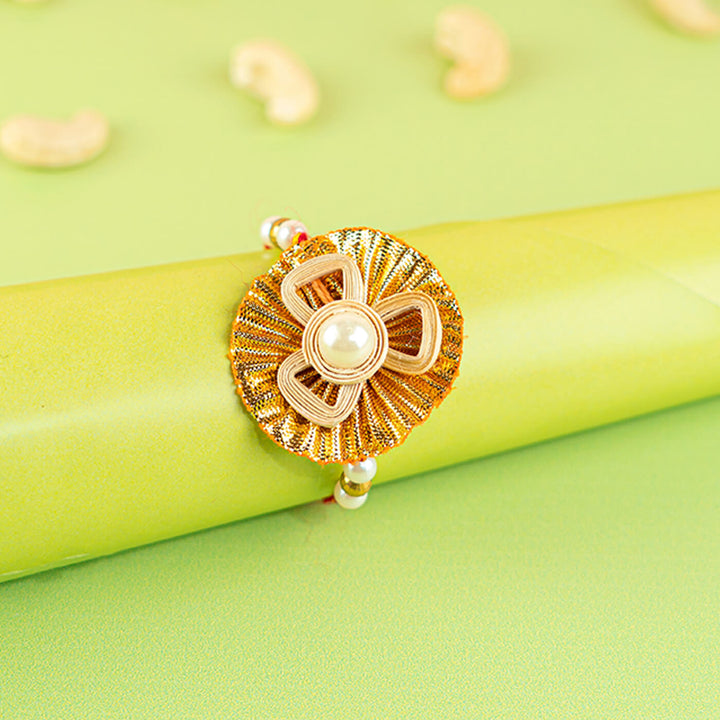 Ecofriendly Bamboo Quilled Rakhi With Gota Resham Thread - Rakhi on gift wrap display