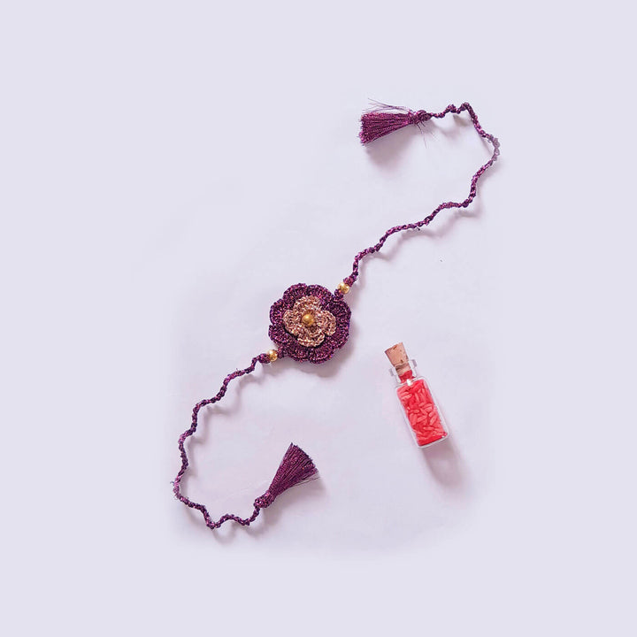 Double Flower Zari Rakhi - Flat Lay with Vial