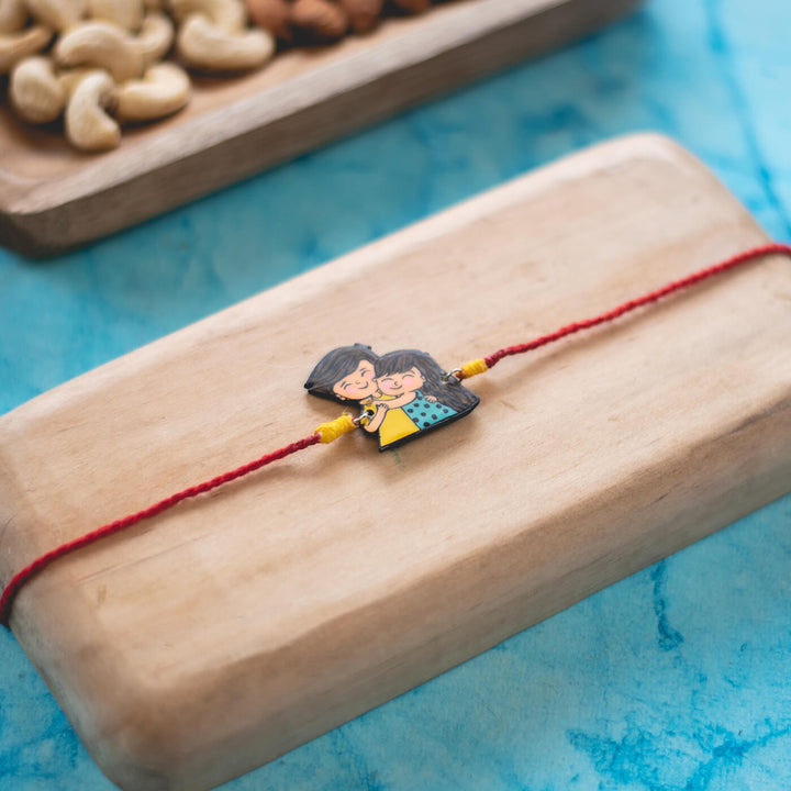 Handpainted Sibling Illustration Rakhi With Roli Chawal