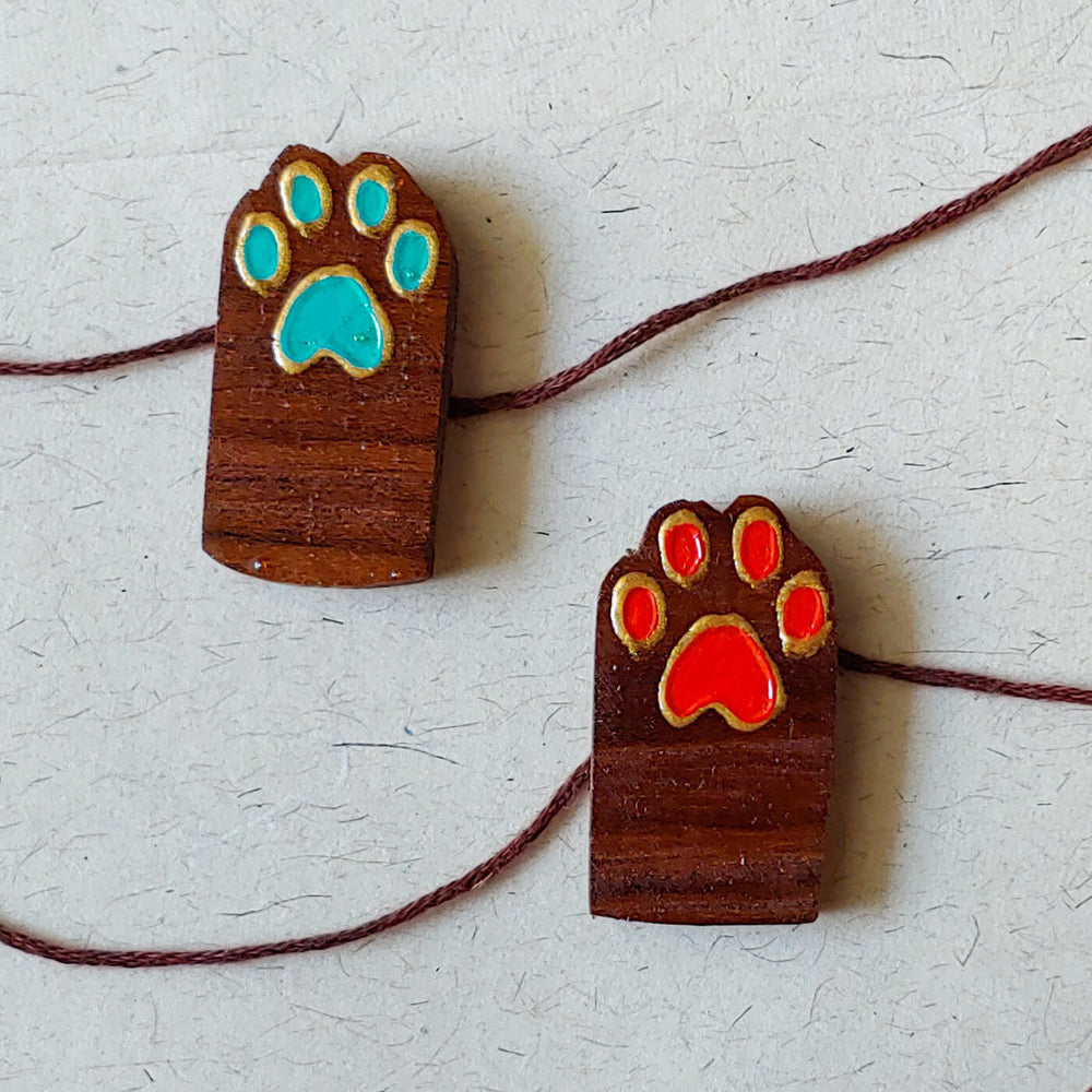 Handpainted Wooden Rakhi Set Of 2 Paws - Pair Front View with Colored Paw Prints