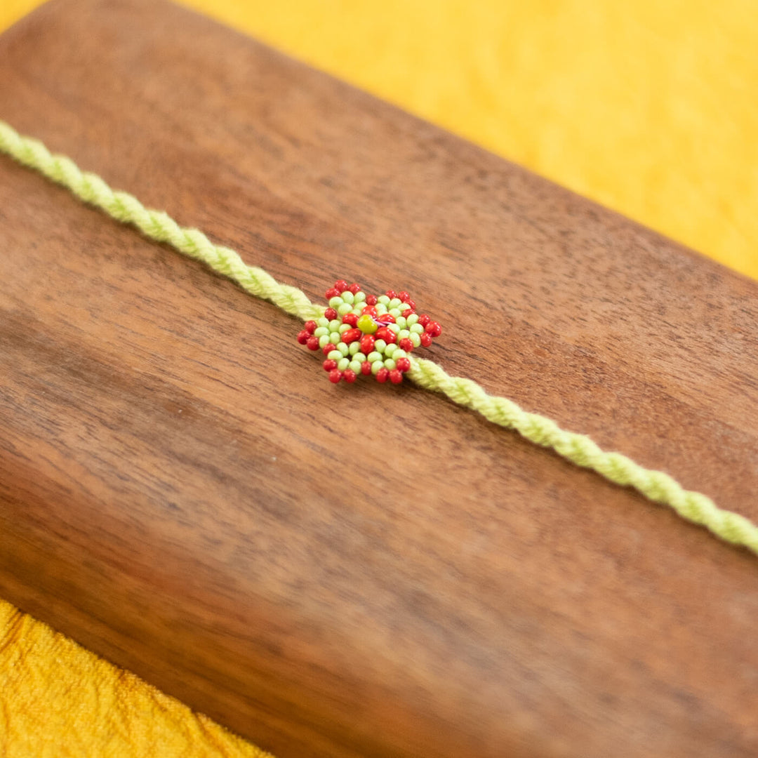 Sitara Collection Glass Beeds Rakhi Red Orange - Close-up of Beaded Centerpiece